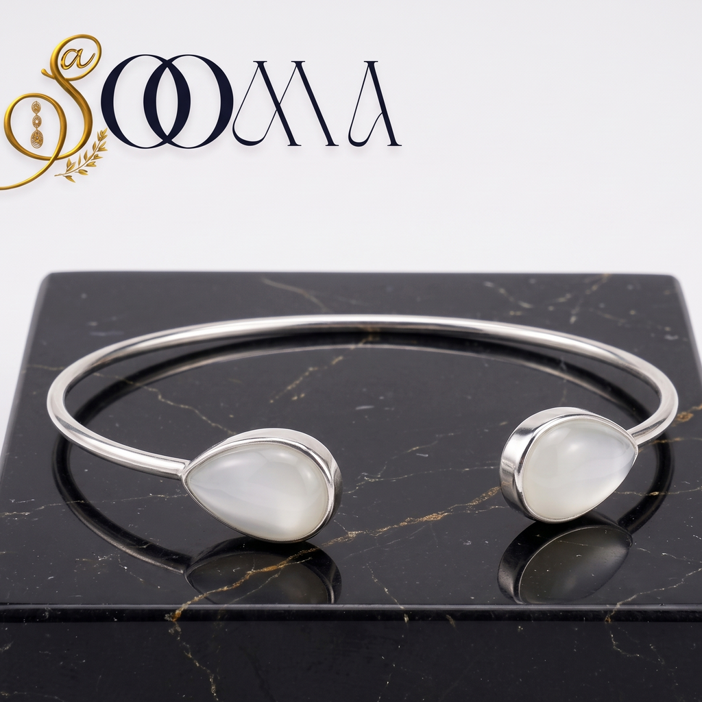 Sooma brand open cuff silver ankle kada with twin teardrop moonstone gemstones on black marble