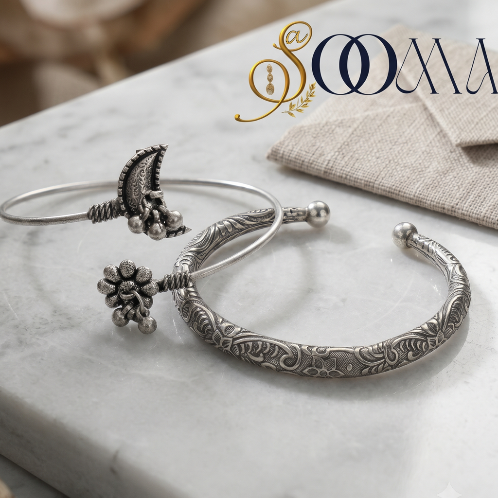 Sooma brand flat lay view of 2-piece silver ankle stack featuring a crescent moon flower ghungroo bypass cuff and engraved floral HASLI kada on marble