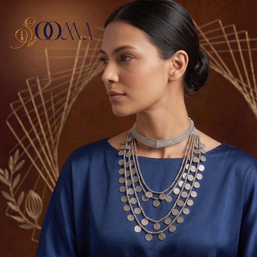 Model in royal blue silk top wearing a stacked oxidized silver geometric V Hasli choker and 4-layer coin necklace