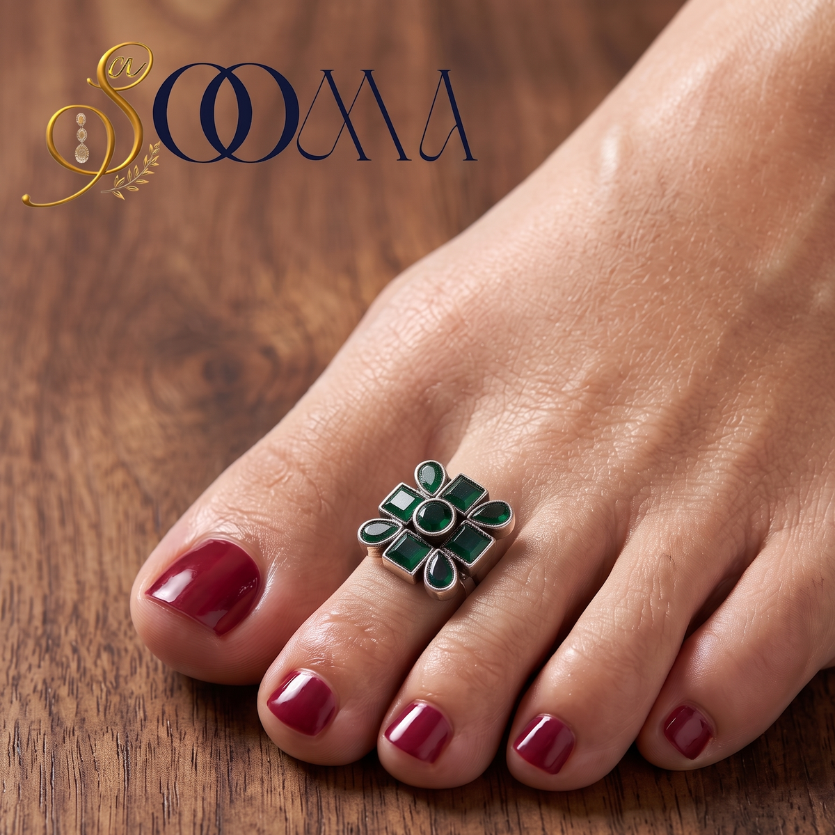 Front view of model feet with deep red polish wearing an oxidized silver geometric green onyx toe ring on wooden background