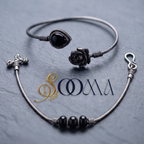 Sooma brand flat lay view of 2-piece ankle stack featuring carved rose teardrop onyx bypass cuff and black bead snake chain on dark slate