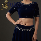 Model showcasing an antique oxidised silver floral kamarbandh paired with a navy blue velvet lehenga set.