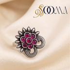 Sooma brand handcrafted oxidized silver sunburst toe ring with royal pink cabochon stones displayed flat on cream satin