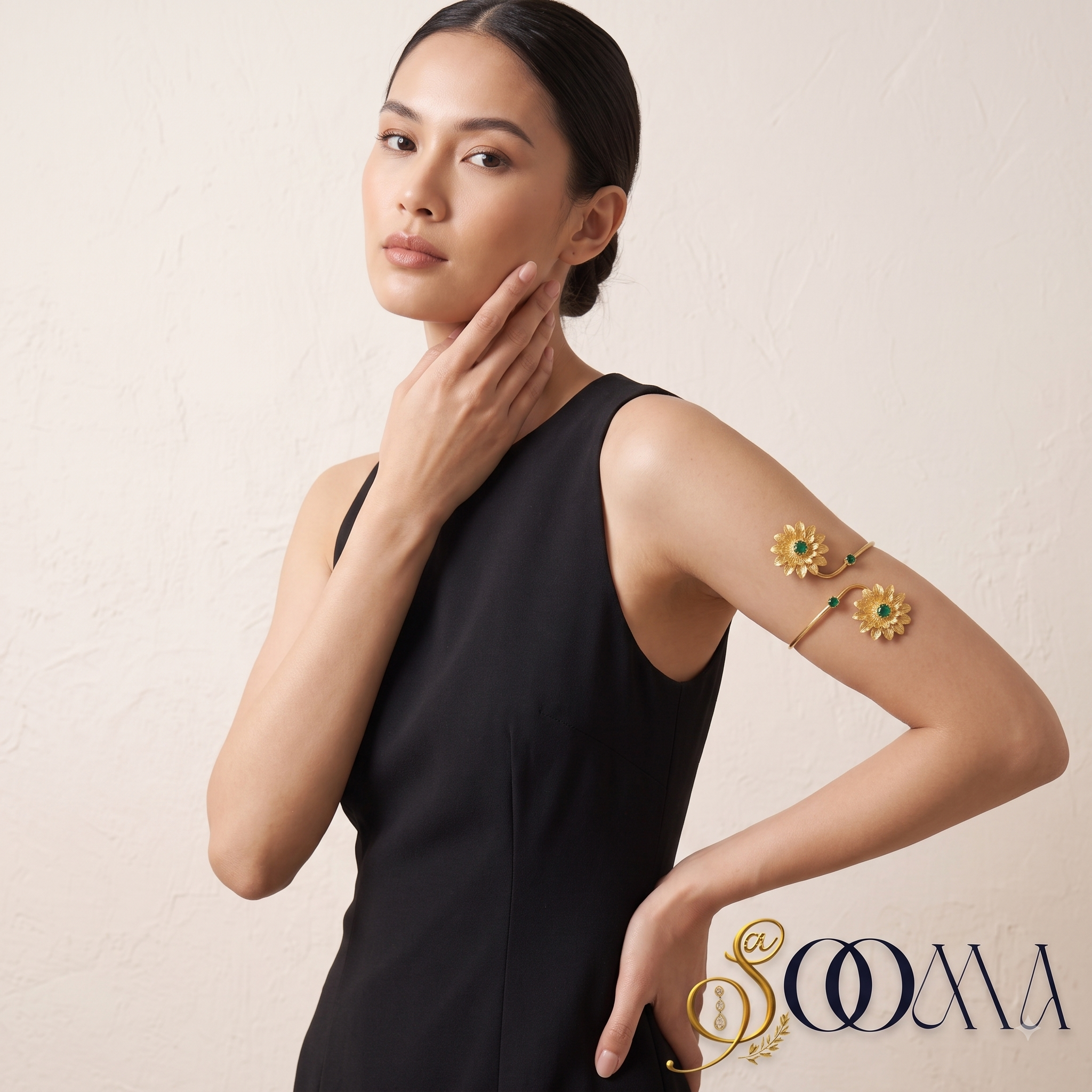 Full view of model styling a matte gold floral armlet bajuband with a sleeveless black evening dress