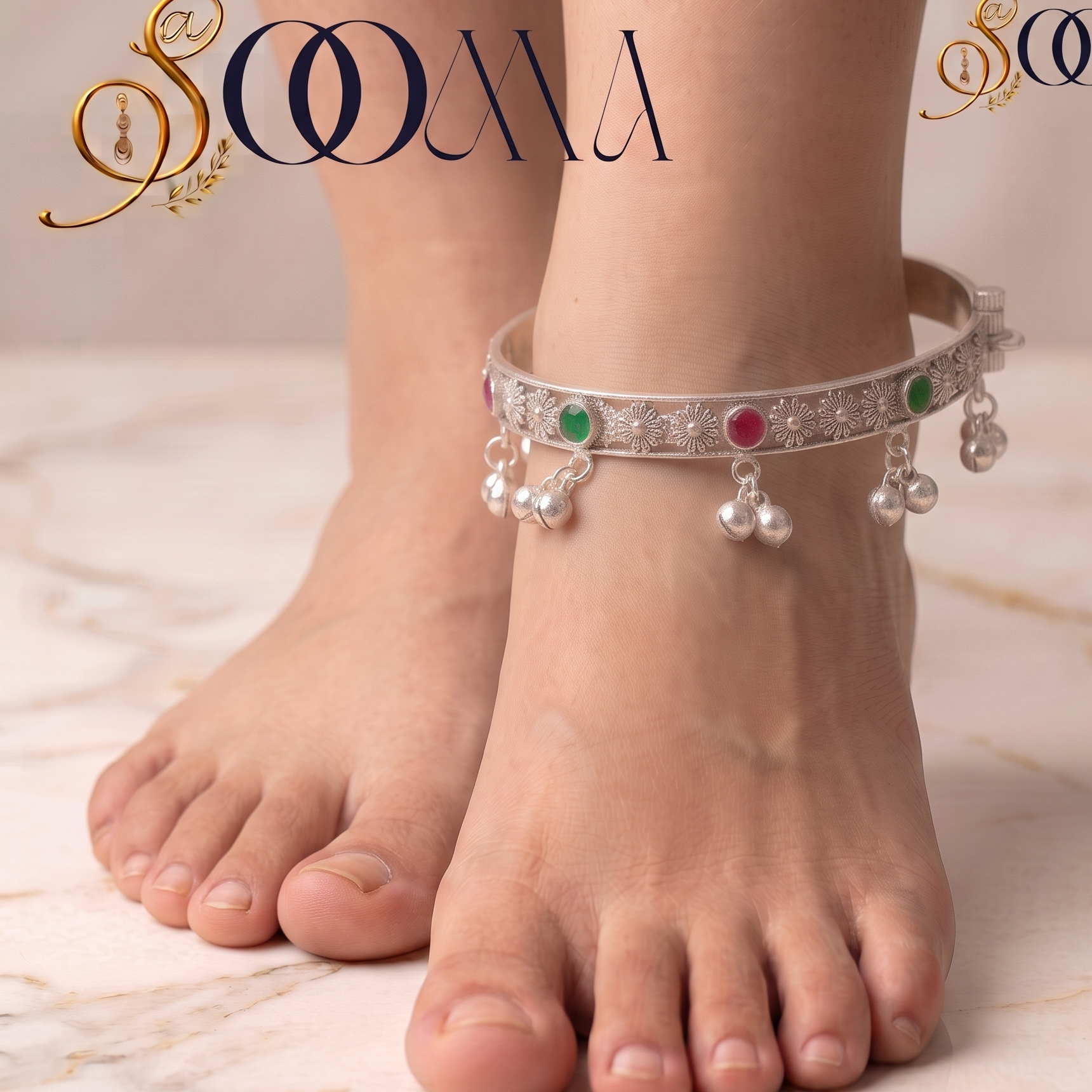 Close-up of woman's ankle showcasing hinged oxidized silver payal kada with green and ruby cabochon stones