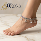 Side profile view of model wearing handcrafted oxidized silver floral ankle kada with red and green stones