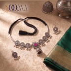 Sooma brand oxidized silver Hasli choker set with pink stone lotus motif and matching earrings displayed flat on cream fabric