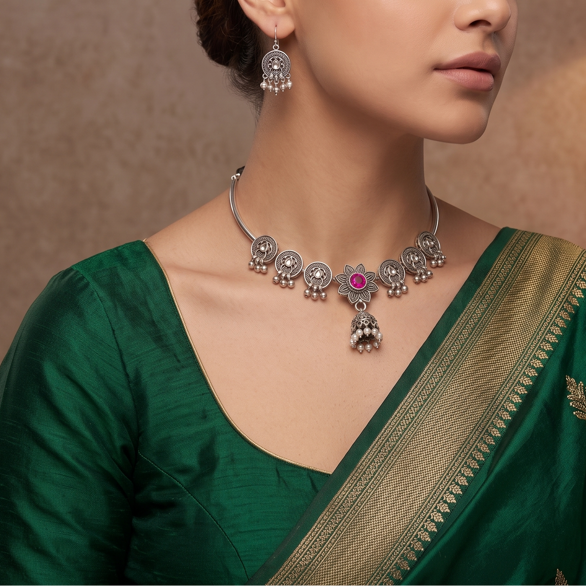 Sooma brand oxidized silver Hasli choker set with pink stone lotus motif and matching earrings displayed flat on cream fabric