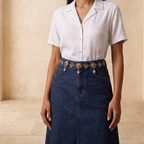Front close-up view of silver stone-studded kamarbandh with cowrie shell drops on denim skirt