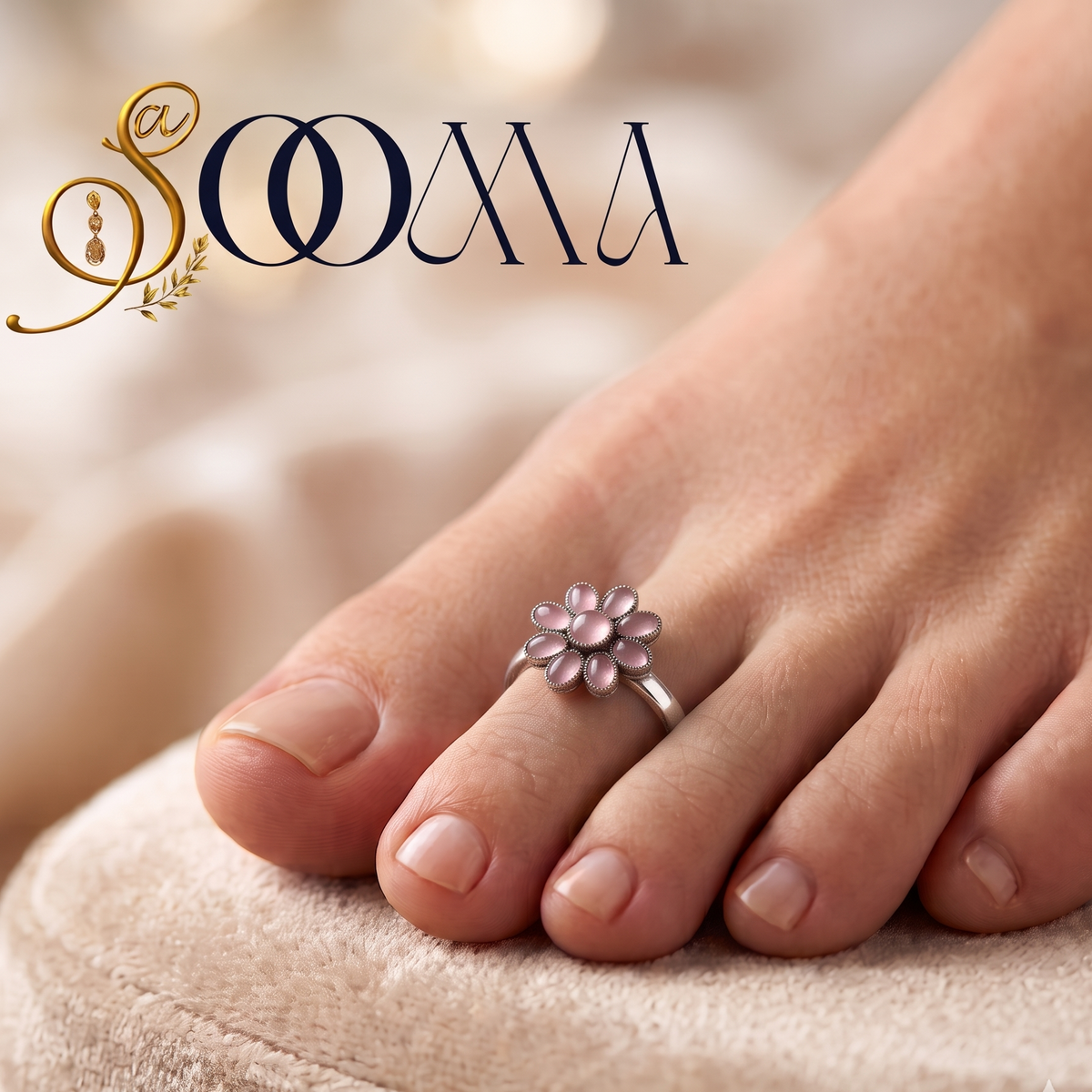 Front view of model feet on linen fabric wearing an oxidized silver pink onyx flower toe ring