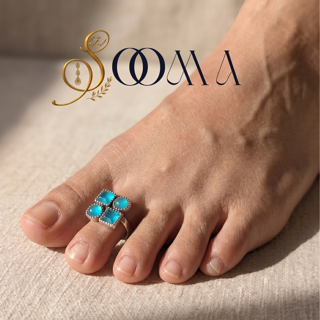 Model's foot wearing an adjustable silver geometric quad toe ring with four bright turquoise stones on a sunlit beige linen fabric
