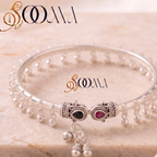 Sooma brand silver ghungroo ankle kada with dual stone elephant terminals displayed flat on marble