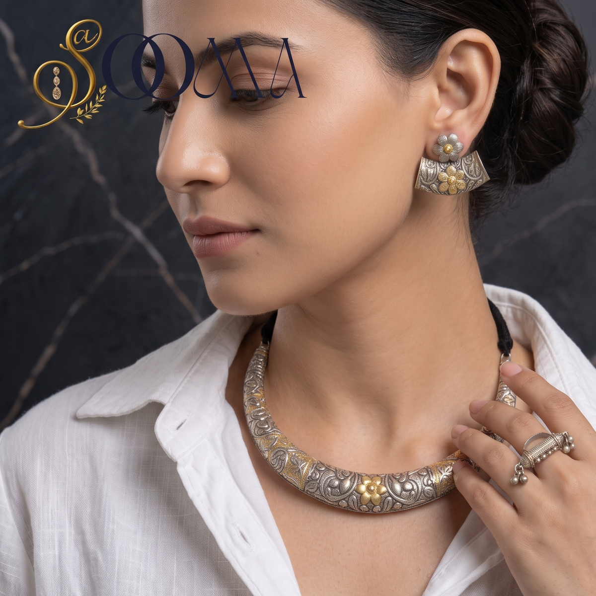 Model in white linen shirt wearing dual-tone oxidized silver and gold carved Hasli necklace set with matching earrings