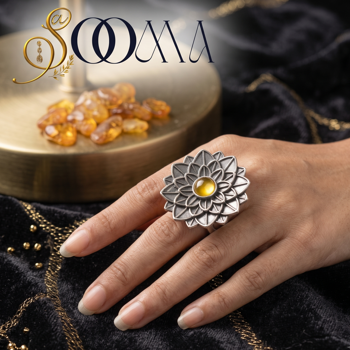 Sooma brand handcrafted oxidized silver multi-tiered lotus ring with an amber yellow stone cabochon displayed on beige background