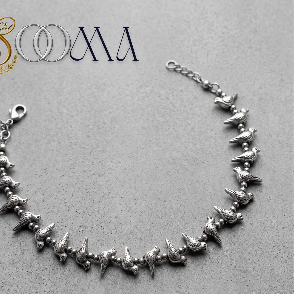 Sooma brand handcrafted oxidized silver bird charm anklet with lobster clasp displayed flat on grey surface