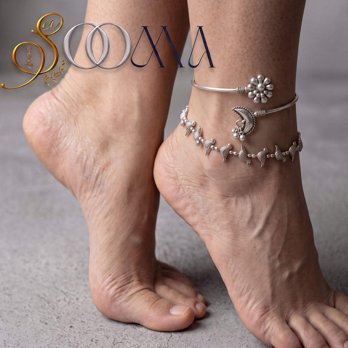 A close-up lifestyle shot of a person's feet and ankles wearing three silver-toned ankle bracelets: a bangle with a flower motif, a bangle with a crescent moon and floral charm, and a beaded chain anklet. The brand logo 'SOONA' is visible in the top left corner.