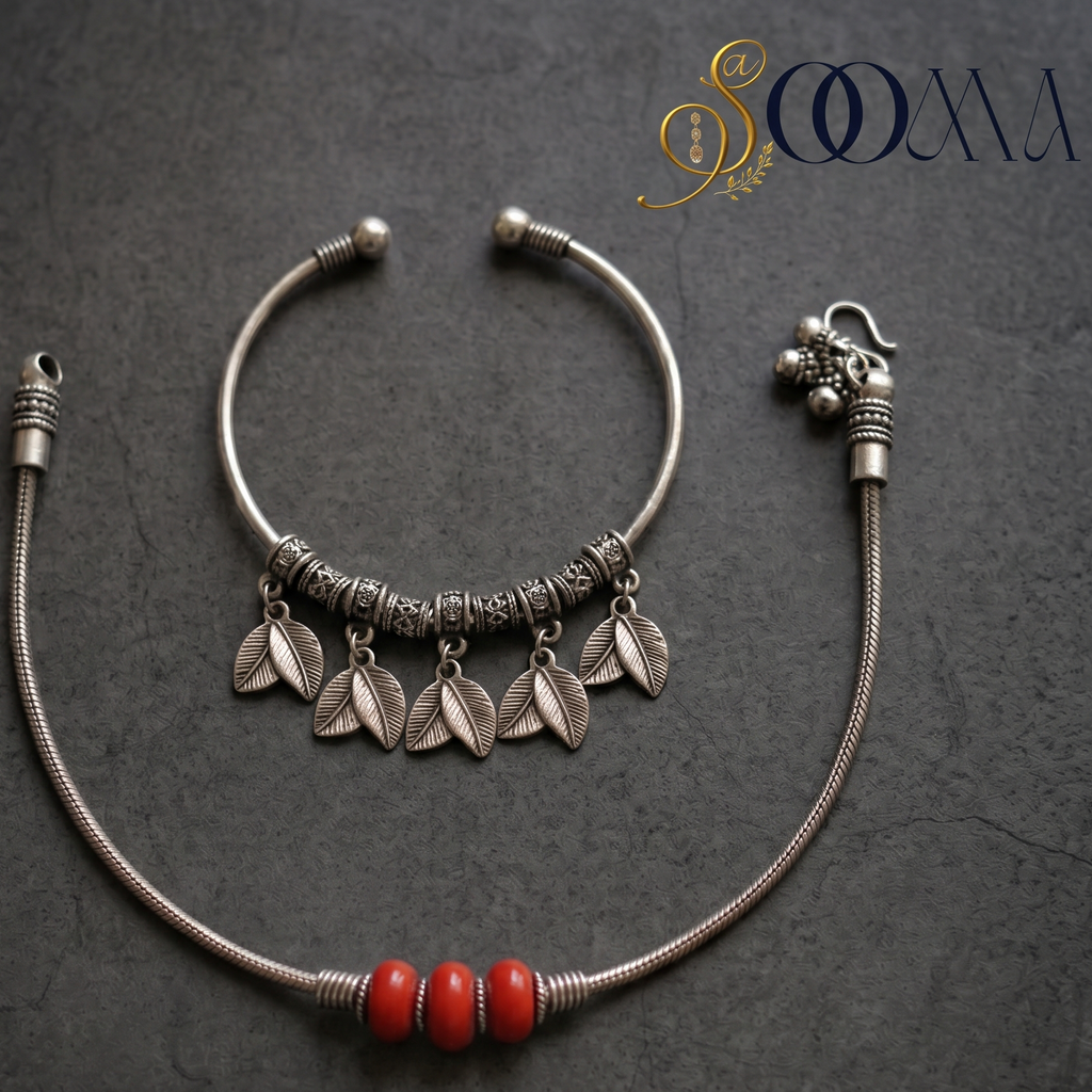 Sooma brand flat lay view of 2-piece ankle stack featuring carved leaf charm cuff and red carnelian bead snake chain on dark stone surface