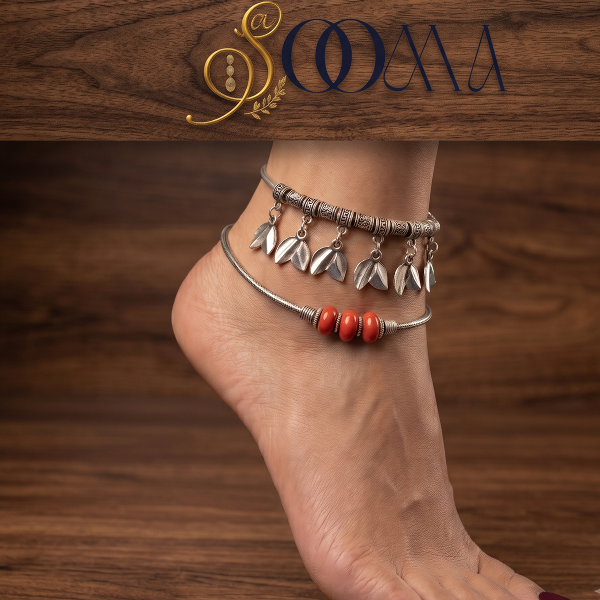 Close-up view of woman's foot adorned with a 2-piece silver leaf charm and red stone bead layered anklet stack