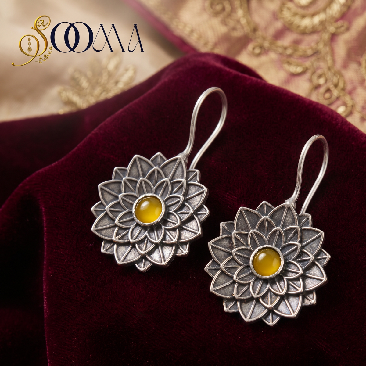 Pair of Sooma brand handcrafted oxidized silver lotus bugadi ear cuffs with yellow citrine centerpieces displayed on red velvet