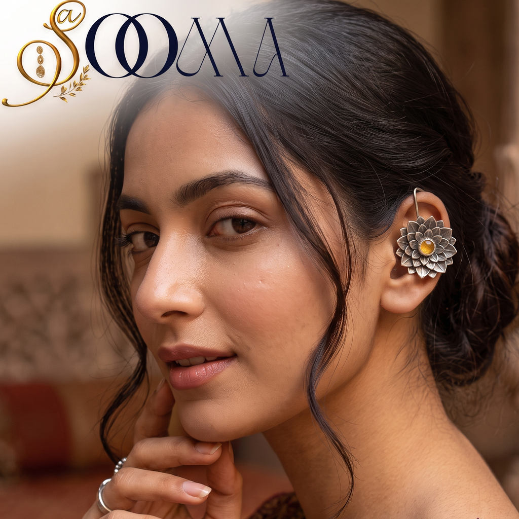 Close-up profile view of model adorned with a clip-on silver lotus flower yellow gemstone bugadi cuff against ethnic attire