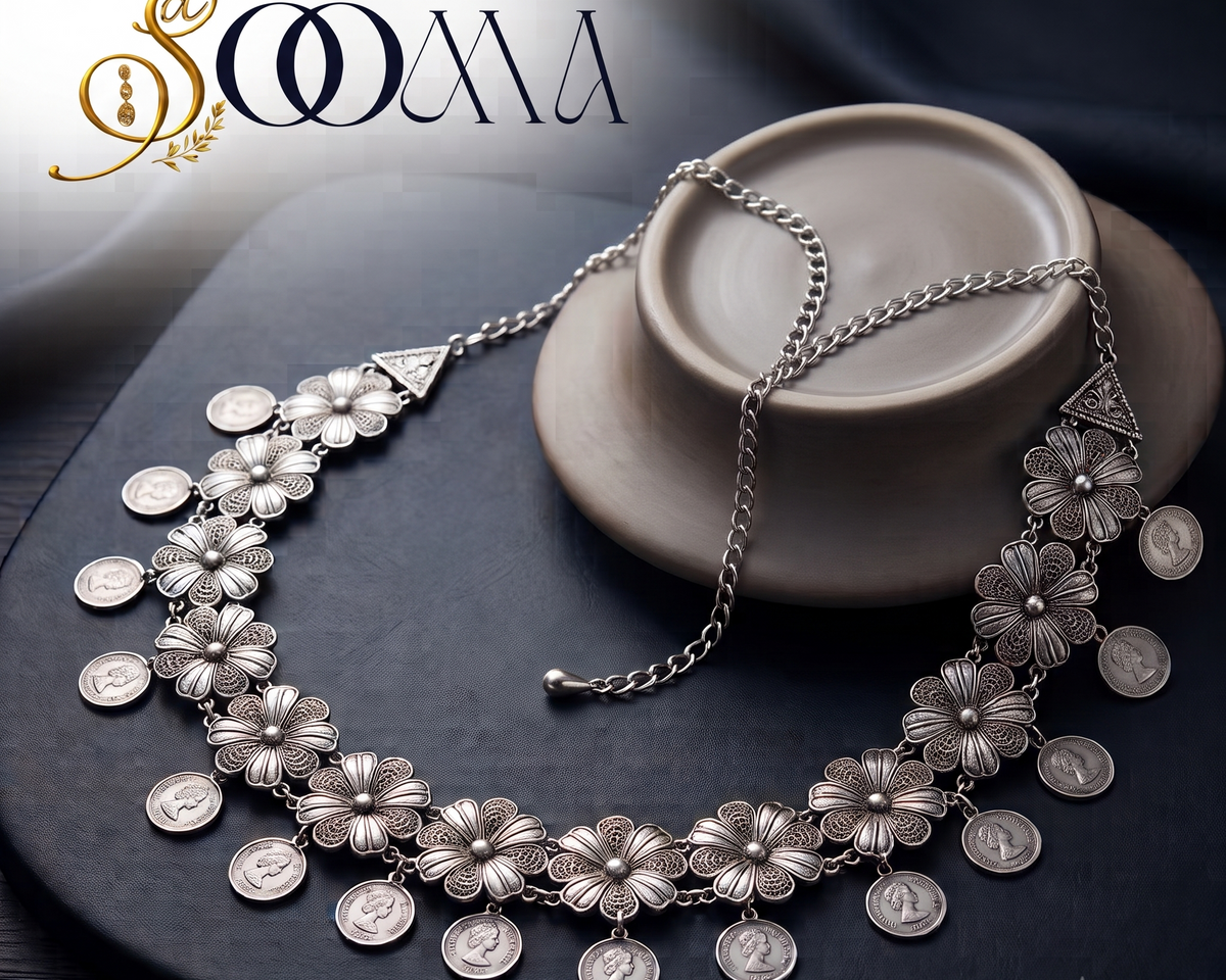 Sooma brand oxidized silver filigree floral and coin drop waistband displayed flat on dark background with ceramic display