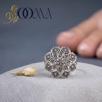 Macro close-up shot of Sooma brand oxidized silver mandala floral toe ring displayed on grey silk