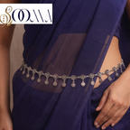 Front view of model wearing oxidized silver floral rosette and coin drop waist chain cinching a dark blue chiffon saree