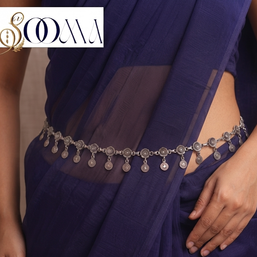 Front view of model wearing oxidized silver floral rosette and coin drop waist chain cinching a dark blue chiffon saree