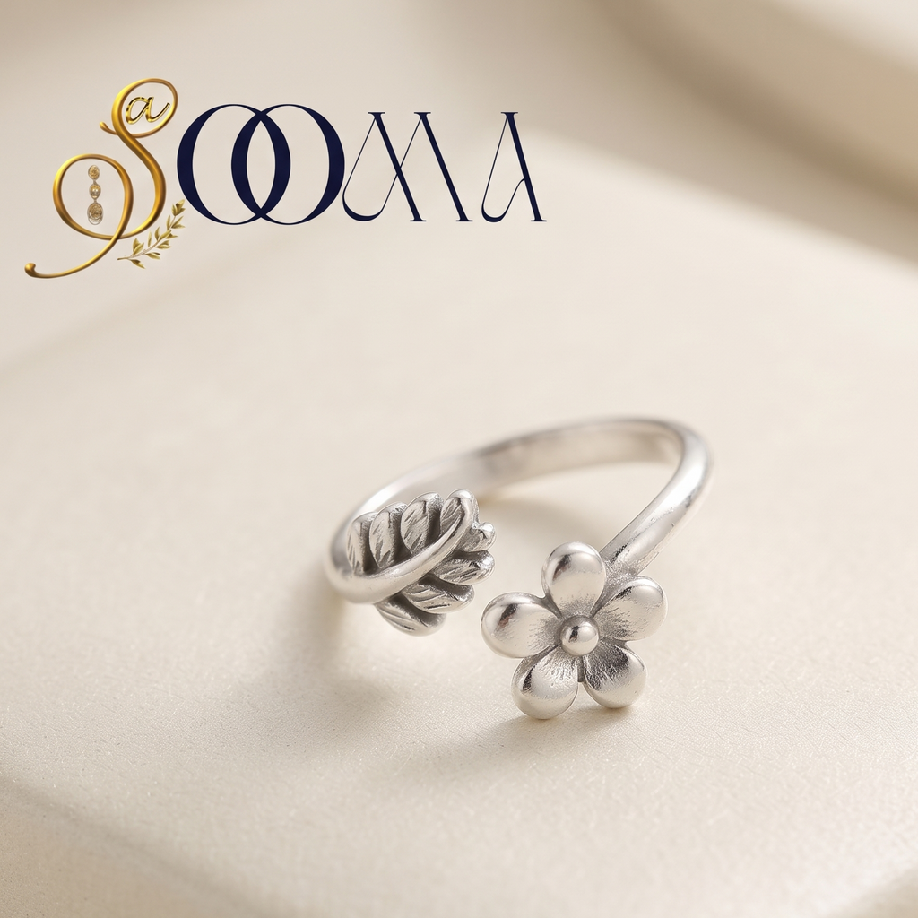 Sooma brand handcrafted oxidized silver flower and leaf adjustable bypass toe ring displayed on cream surface