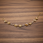 Detailed close-up shot showing cubic zirconia flower motif and pearl clusters of gold anklet