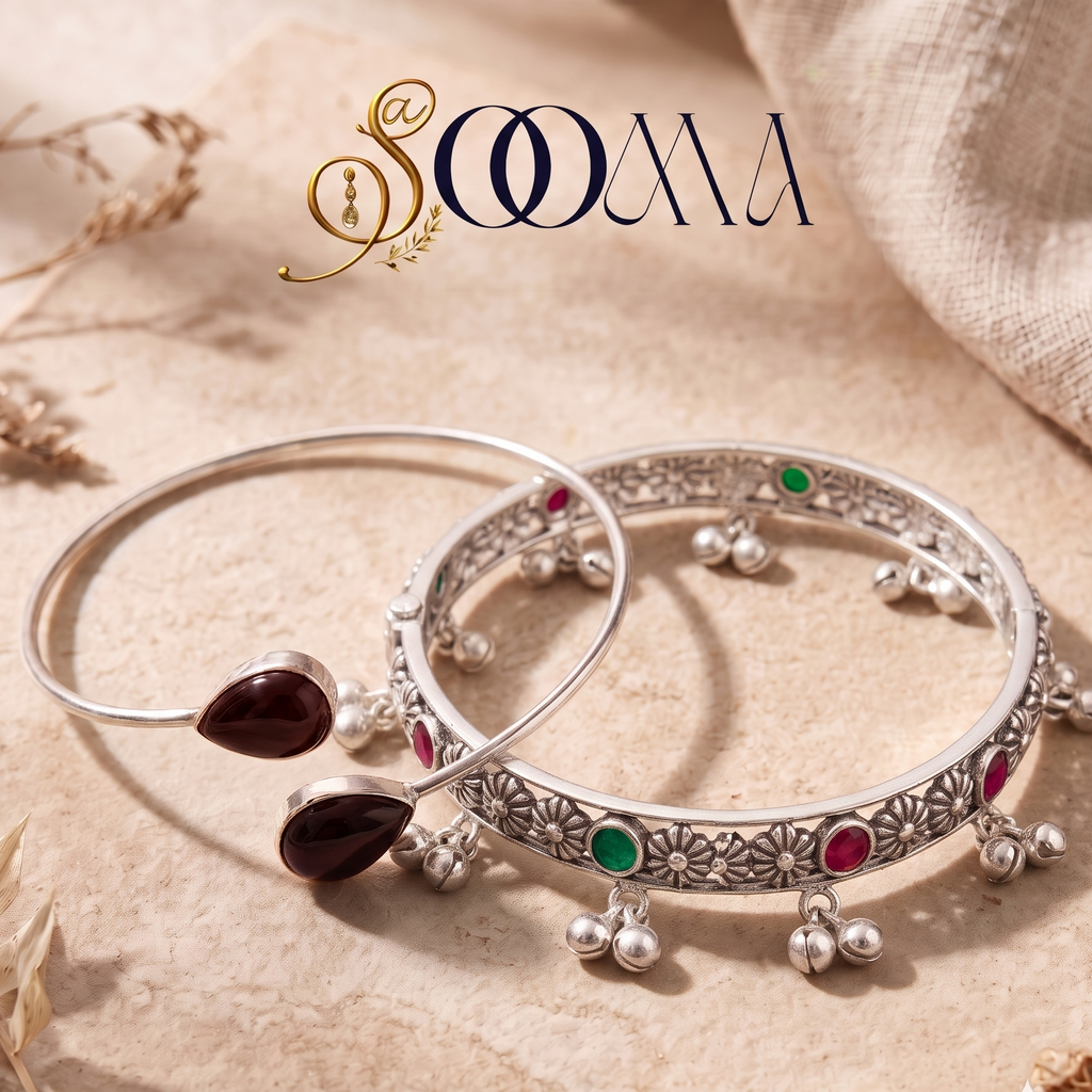 Sooma brand flat lay view of 2-piece ankle stack featuring a carnelian bypass cuff and ruby-emerald floral ghungroo kada on beige stone surface