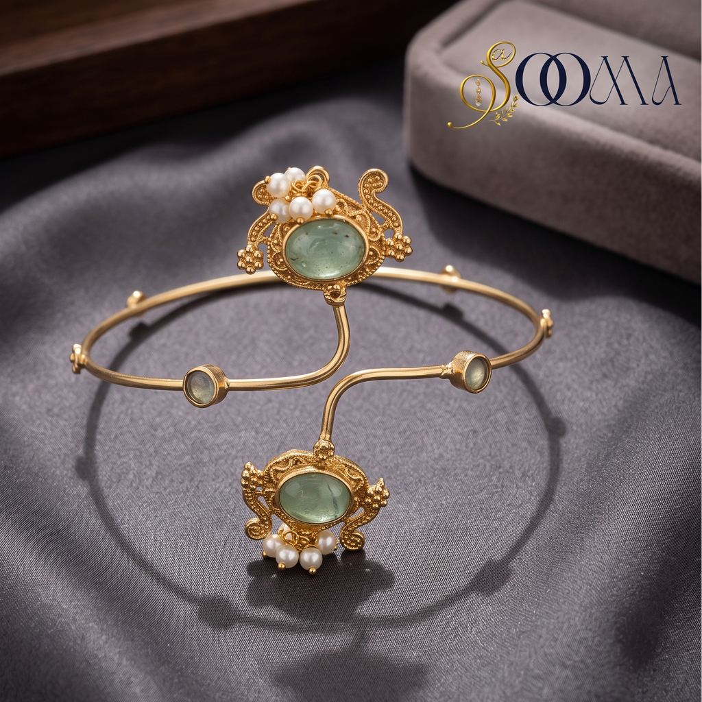 Sooma brand gold emerald-green stone and pearl armlet bajuband displayed flat on grey satin