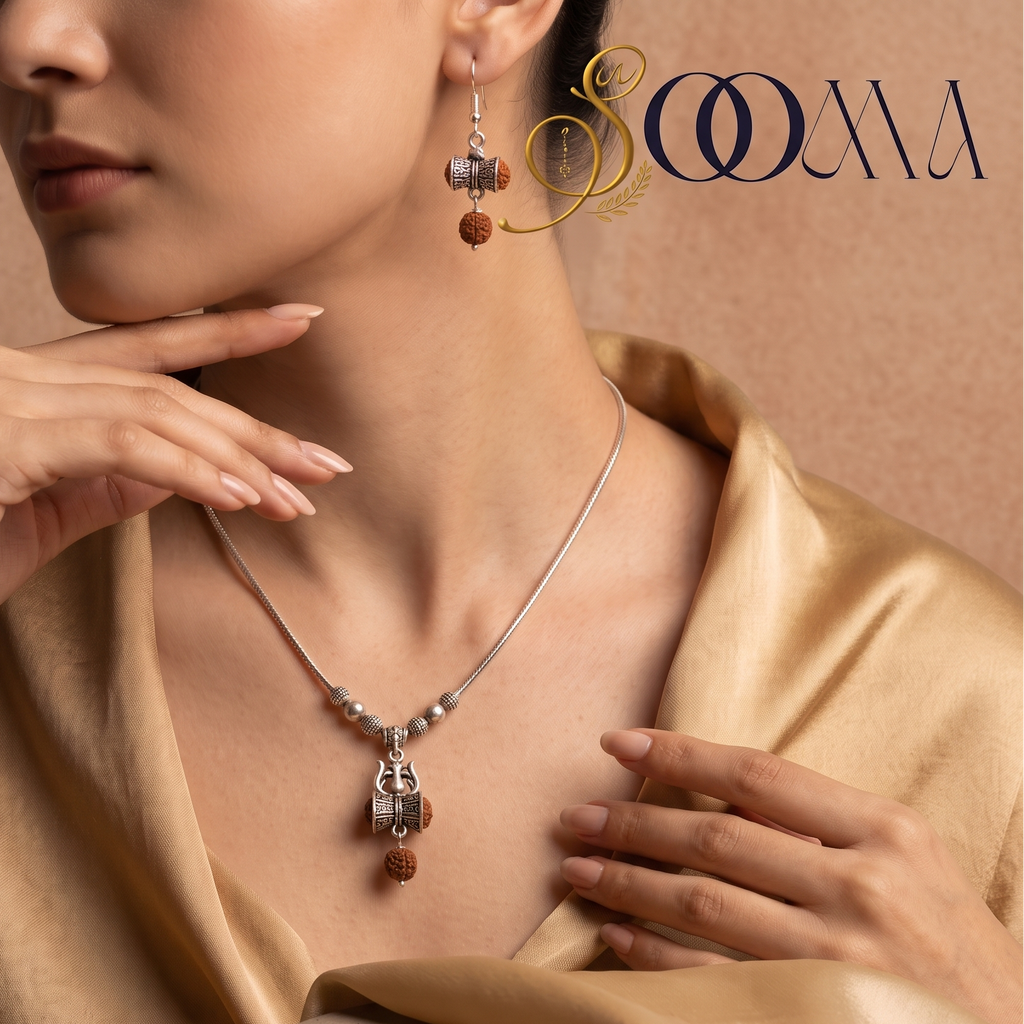 Model in gold silk draped top wearing handcrafted oxidized silver Trishul Damru Rudraksha necklace set with matching earrings