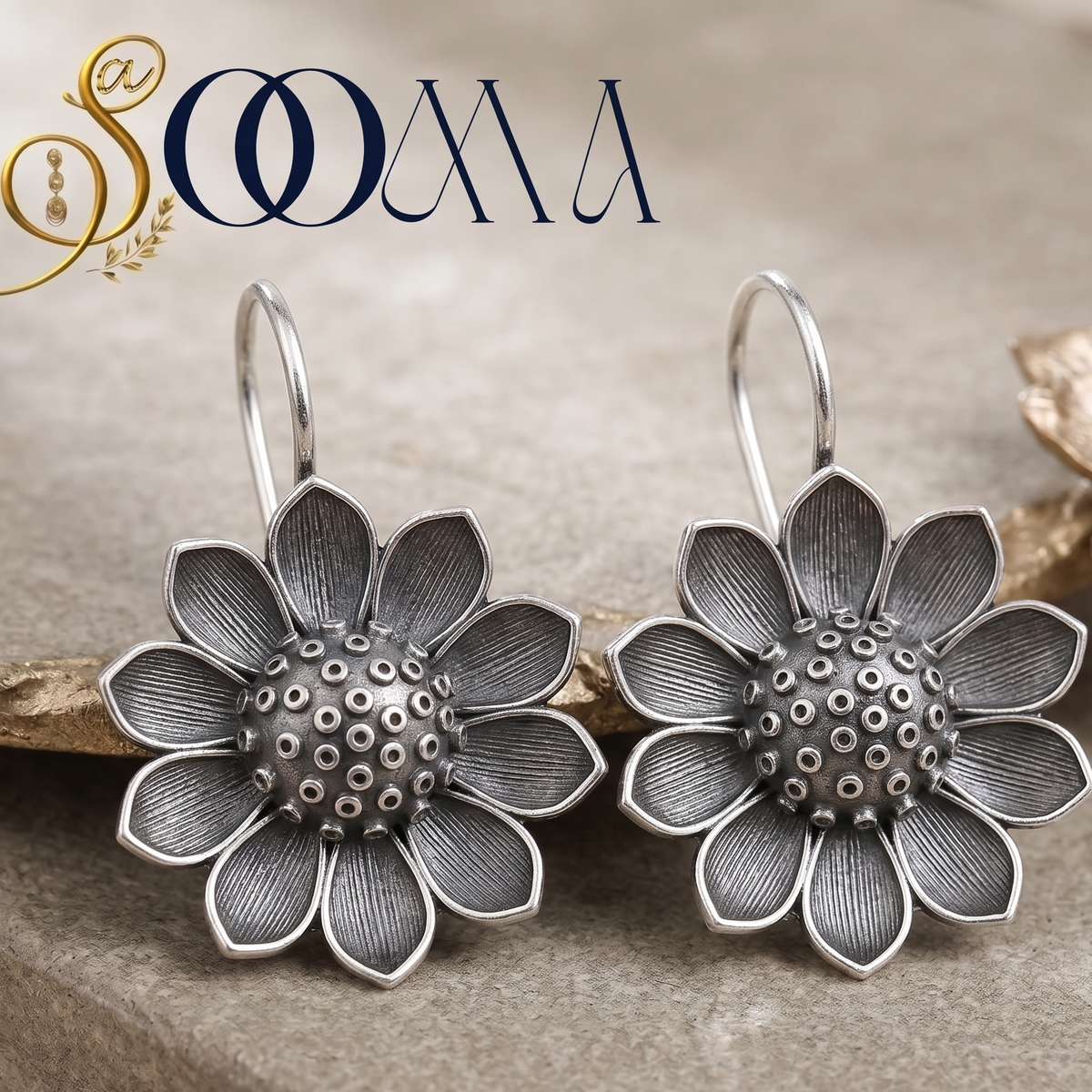 Pair of Sooma brand handcrafted non-piercing oxidized silver sunflower bugadi ear cuffs displayed on beige stone block