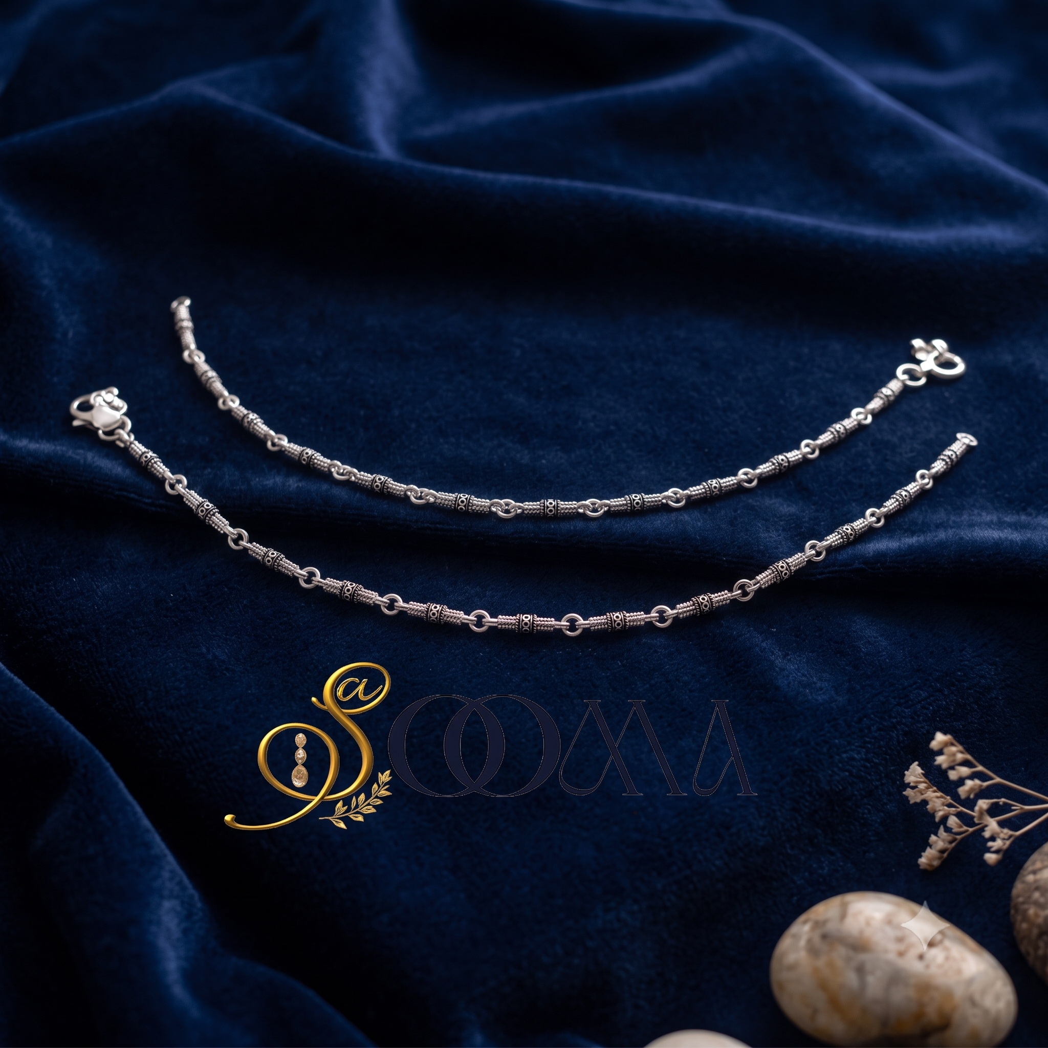 Sooma brand pair of minimalist oxidized silver link and bead payal anklets lying flat on blue velvet fabric