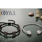 Sooma brand display banner showing 2-piece ankle stack with black macrame butterfly cord and teardrop moonstone bypass cuff flat lay on green marble