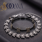 Sooma brand flat lay view of 2-piece ankle stack featuring braided cord butterfly anklet and full silver linked butterfly chain on dark grey backdrop