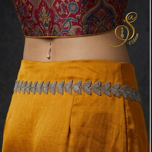 Back view close-up of model waist wearing oxidized silver butterfly kamarbandh over mustard yellow draped skirt