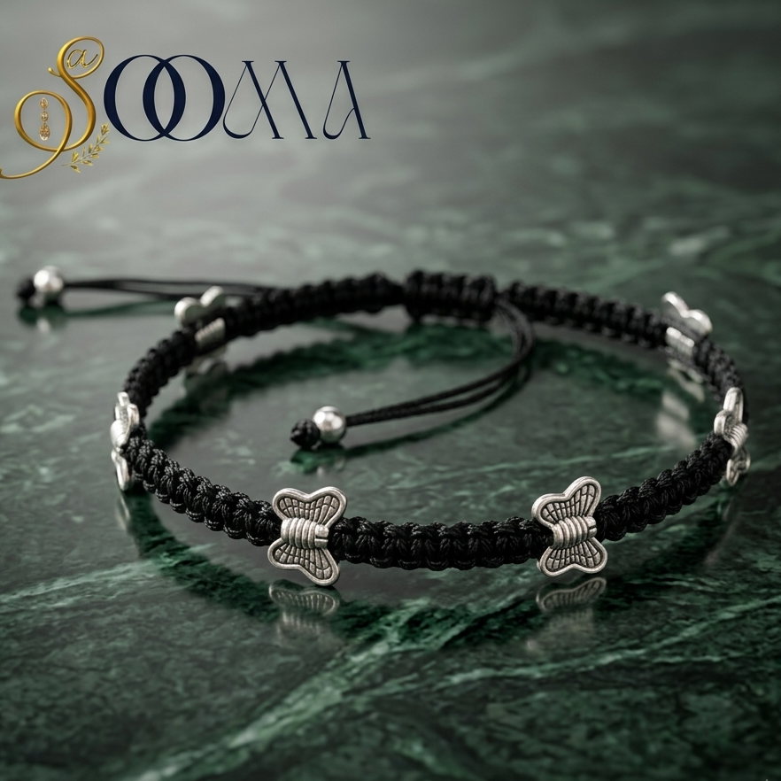 Close-up view of adjustable black thread anklet with silver butterfly charms on ankle