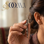 Hand holding a non-piercing oxidized silver Trishul and Om bugadi ear cuff displaying the clip-on hook structure