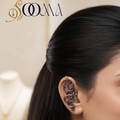 Side profile view of woman wearing a sacred non-piercing oxidized silver Trishul and Om bugadi ear cuff along her ear cartilage