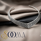 Sooma brand oxidized silver geometric V-neck Hasli choker displayed flat on beige satin fabric