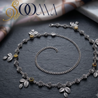 Sooma brand oxidized silver floral waistbelt with extension chain displayed flat on black slate tile
