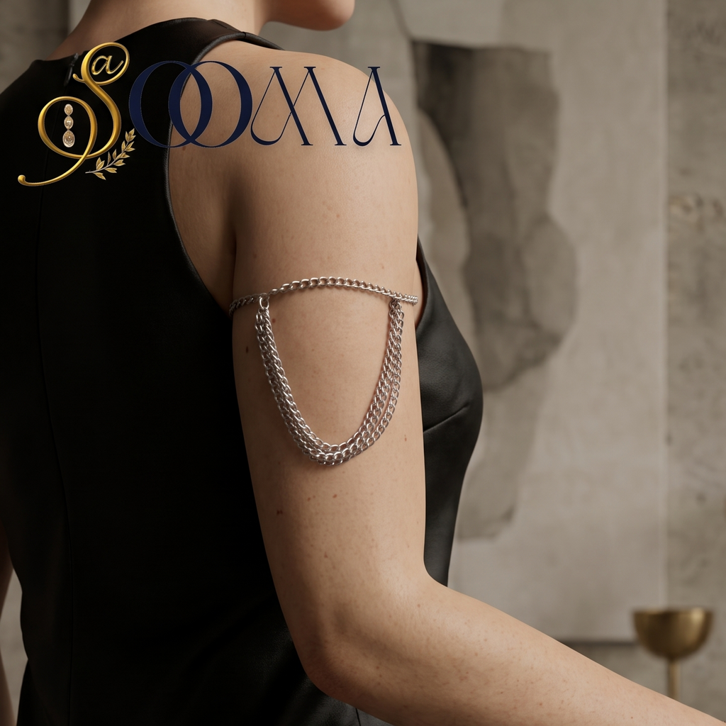 ="Model wearing a polished silver layered curb chain armlet with draped chains on upper arm