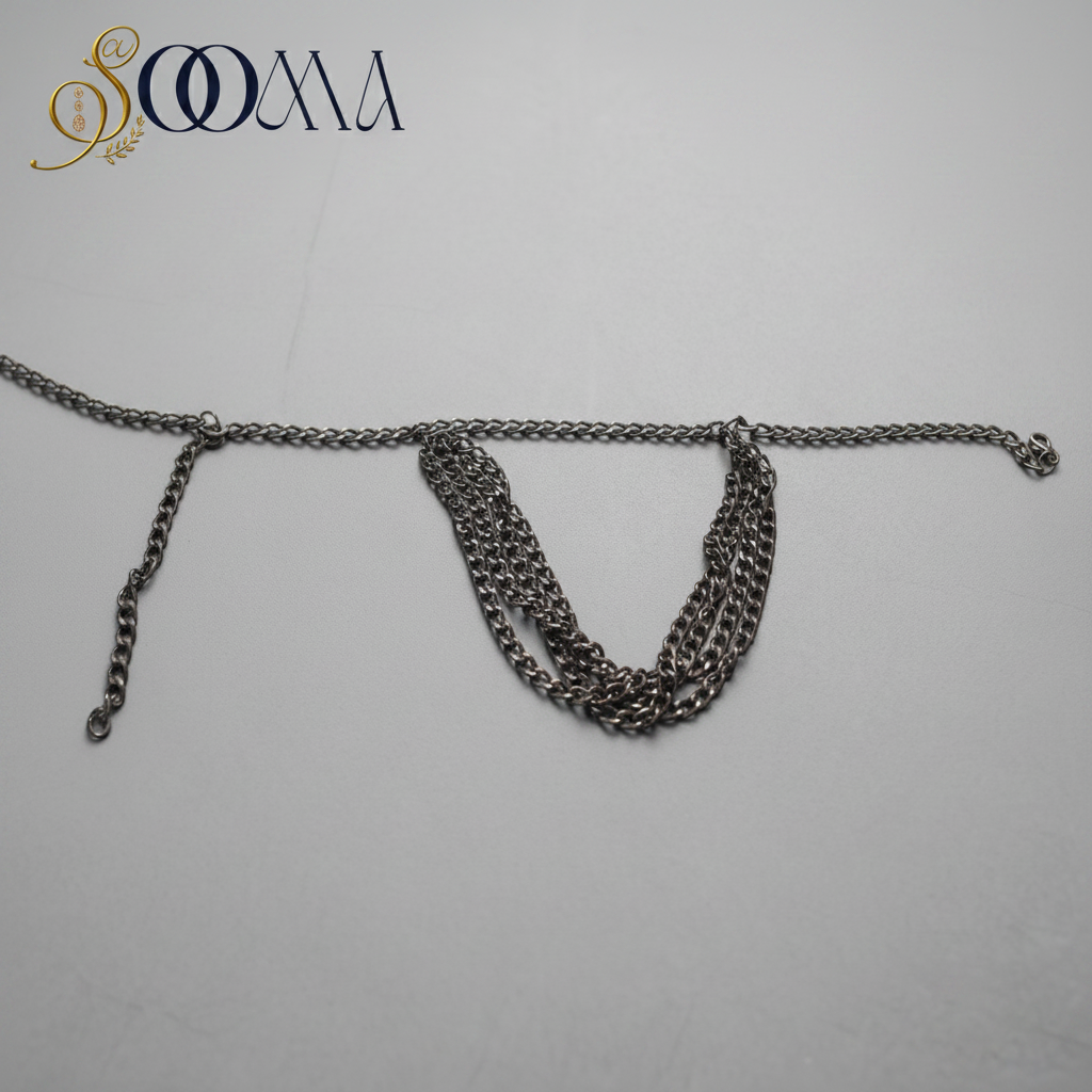 Sooma brand silver-tone layered curb chain armlet displayed flat on dark slate background