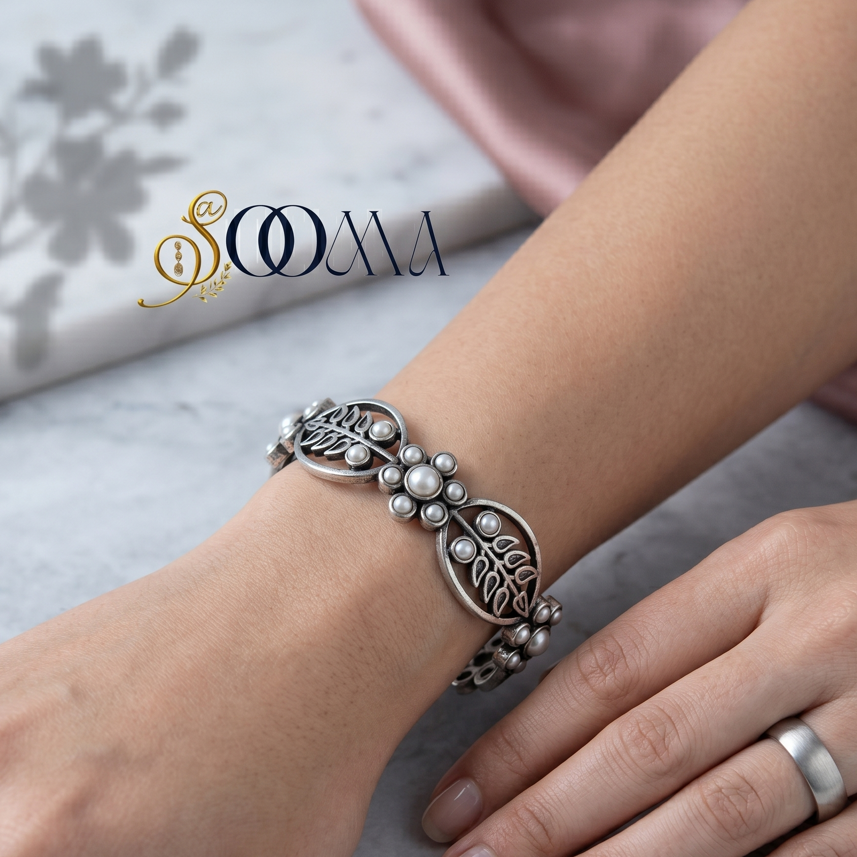 Model's wrist wearing a handcrafted oxidized silver textured link bracelet next to clean minimalist styling
