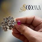 "Close up of Saoma jewelry brand oxidized silver multi floral toe ring featuring a round pink cabochon stone"