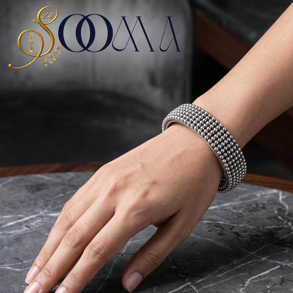 Model's wrist wearing a sleek, minimalist handcrafted silver open cuff bracelet paired with a professional office outfit