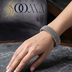 Model's wrist wearing a sleek, minimalist handcrafted silver open cuff bracelet paired with a professional office outfit