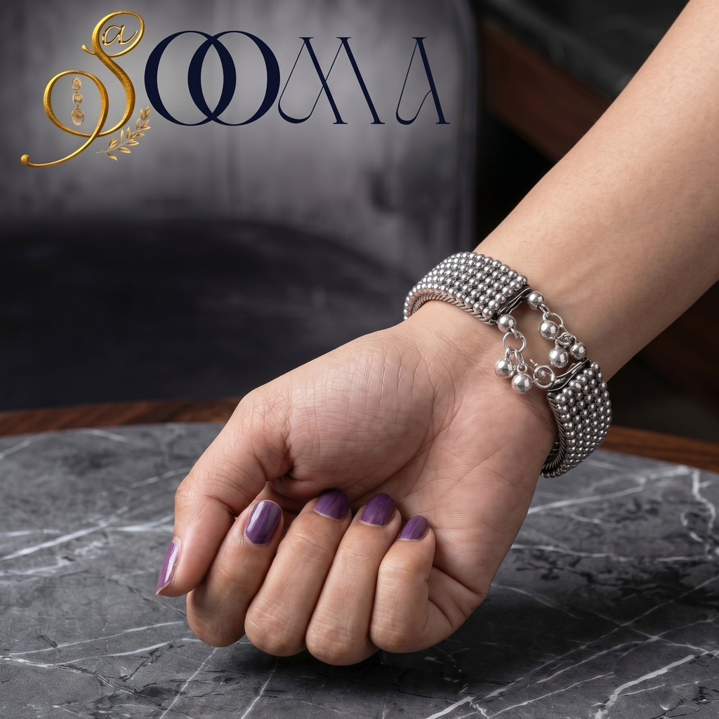 Close up shot of Sooma brand designer minimalist silver open bangle showing the clean architectural finish on a premium textured background